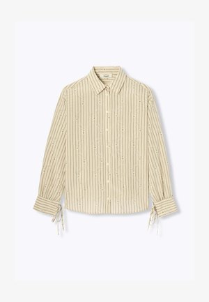 Blouse beige à manches longues avec rayures verticales, petites broderies florales, fermeture par boutons à l'avant, col, et détails noués aux poignets.