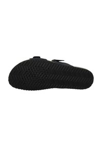 Sole di scarpa sportiva nera con un motivo a zig-zag testurizzato e perforazioni per la presa. Dotata di due cinghie per una chiusura sicura.