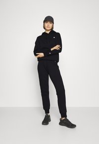 Champion BASIC CUFF PANTS - Träningsbyxor - black