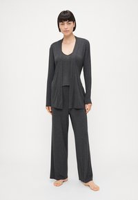 Gray loungewear set with long sleeves, a V-neck top, and wide-leg pants, made from soft, lightweight fabric with a relaxed fit.