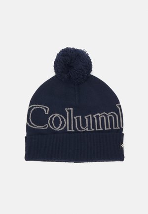 Granatowa wełniana czapka z teksturowanym wykończeniem, z wyraźnym szarym logo "Columbia" i ozdobnym pomponem na czubku.