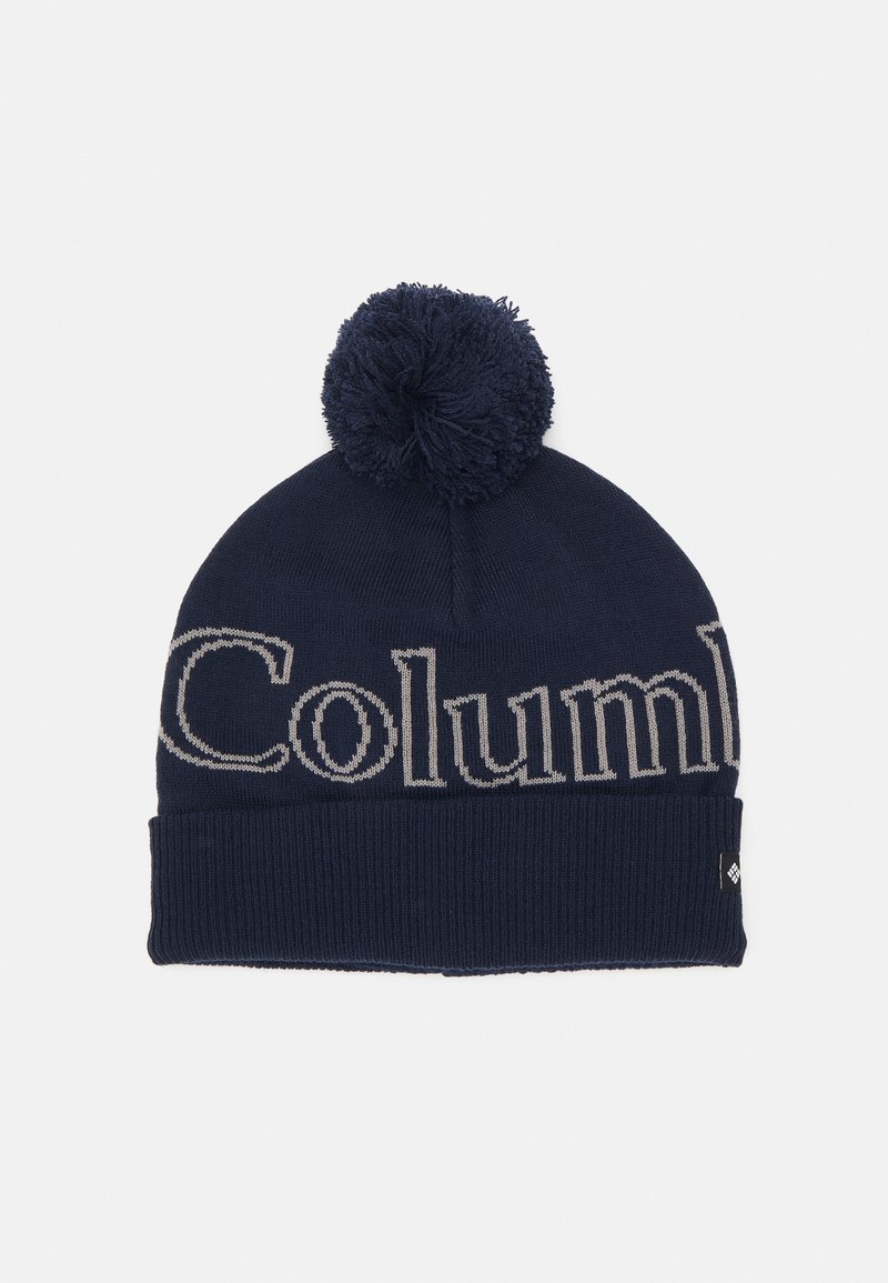 Jūras spēku adīta cepure ar teksturētu apdari, kurai ir izteikta pelēka "Columbia" emblēma un dekoratīvs pom-poms augšpusē.