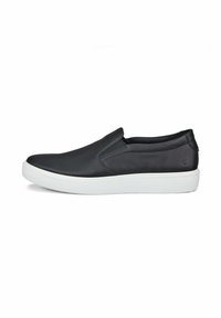 Scarpa nera in pelle senza lacci con tomaia testurizzata, suola in gomma bianca e design minimalista. I dettagli includono un piccolo logo vicino al tallone.
