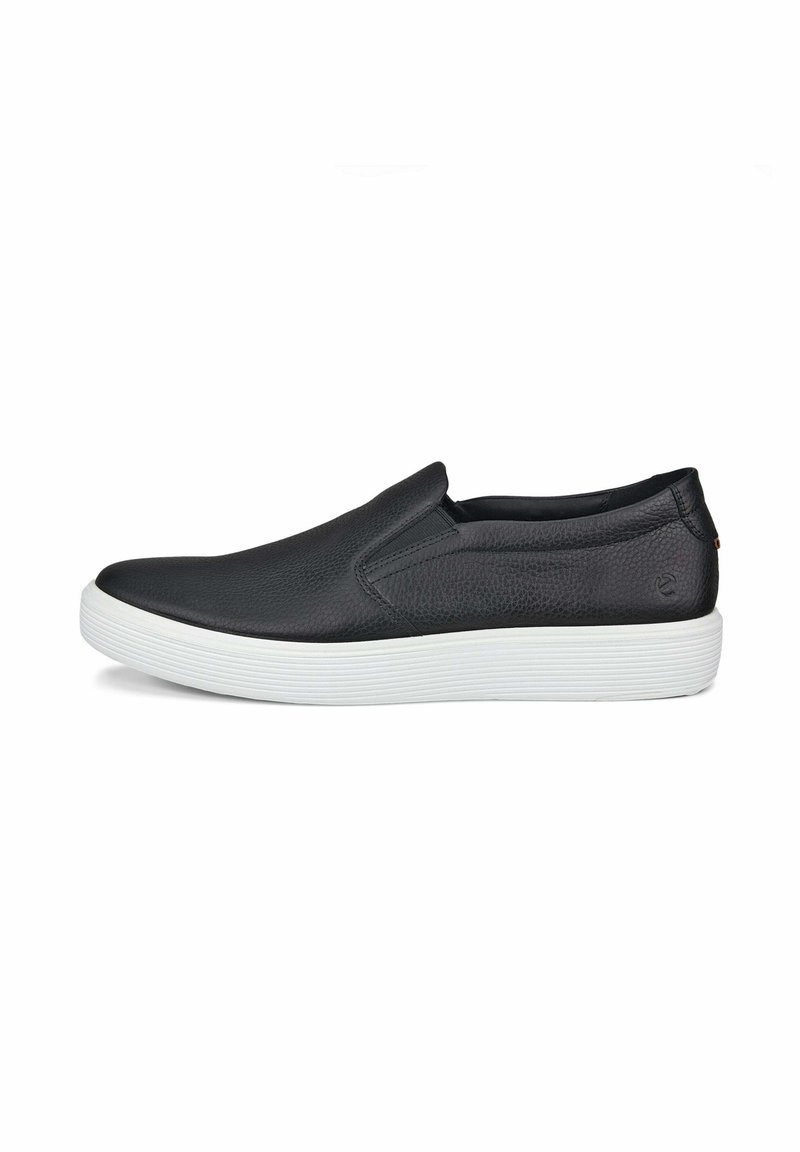 Scarpa nera in pelle senza lacci con tomaia testurizzata, suola in gomma bianca e design minimalista. I dettagli includono un piccolo logo vicino al tallone.