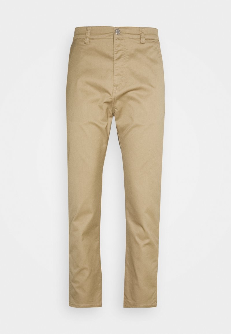 Béžové chinos kalhoty s rovnou nohavicí, vyrobené z bavlny, s knoflíkovým pasem a předními kapsami. Hladká textura, bez vzorů.