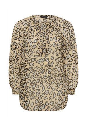 Blouse imprimé léopard beige avec des taches noires et marron, présentant un col à cordon et de longues manches bouffantes. Texture soyeuse.