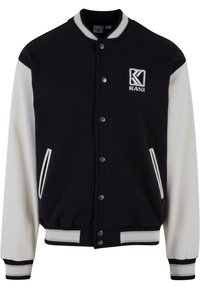 Veste varsity noire et crème, en laine mélangée, avec des poignets côtelés, des boutons pression, des poches latérales et un logo brodé.