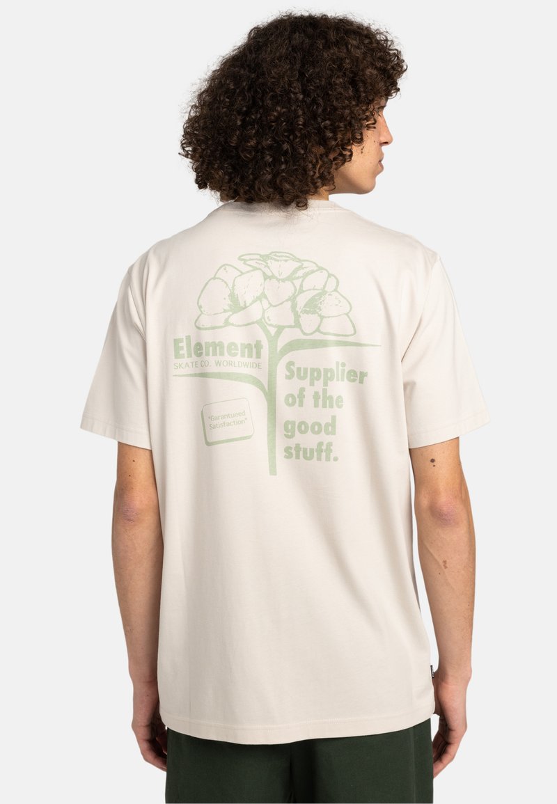 Camiseta de manga corta beige con diseño gráfico verde que presenta flores y texto en la parte posterior. Fabricada en suave material de algodón.