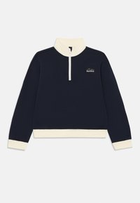 Mörkblå tröja med vita mudd, nederkant, hög krage, halvmatchande dragkedja och texten "Perfekt Outfit" på bröstet.