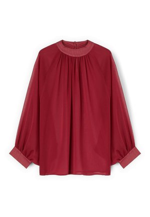 Blusa rossa a maniche lunghe con gioga raccolto, scollo rotondo, chiusura con bottoni sul retro e vestibilità ampia con maniche con risvolto.