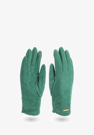 Un paio di guanti in suede verde con un piccolo tag logo sul polso e un sottile dettaglio ricamato sul dito indice.