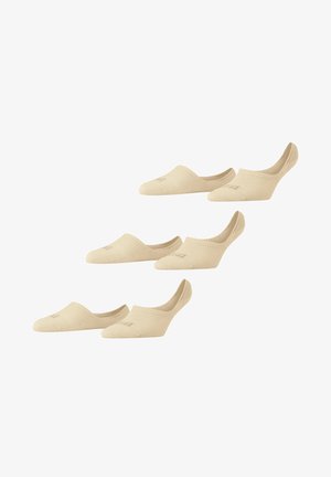 Chaussettes invisibles en coton beige avec bords côtelés et logo discret, présentant un design bas pour un port caché à l'intérieur des chaussures.