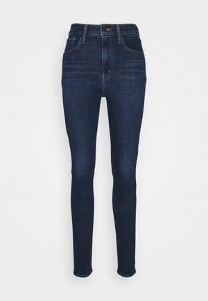 Smaljeans i mørk indigo denim, med høy midje, tradisjonell femlommers design og subtile søm detaljer.