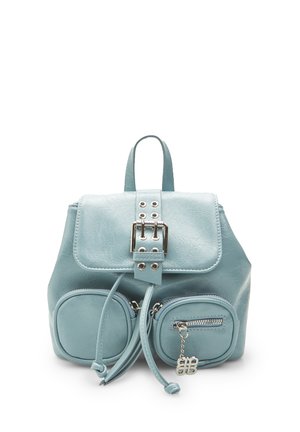Light blue faux leather backpack with a flap closure, silver buckle hardware, and two round zippered front pockets. Smooth texture.