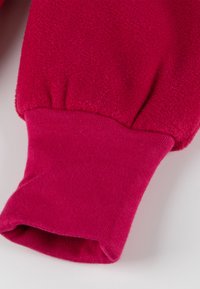 Fleece-Pulloverärmel in leuchtendem Pink, mit elastischen Bündchen und einem weichen, strukturierten Stoff. Glatte Innenauskleidung mit elastischem Finish.