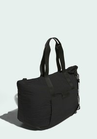 Borsa tote nera realizzata in tessuto leggero, dotata di doppi manici, esterno texturizzato e chiusura con zip. Design semplice e funzionale.