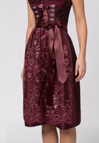 Burgundy dress with floral embroidery and sequins. Fitted bodice with lace-up detail and a satin ribbon belt at the waist.