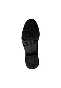 Suela de bota de goma negra con un patrón de textura en la suela, que presenta empuñaduras elevadas y una etiqueta dorada que indica la talla 38.