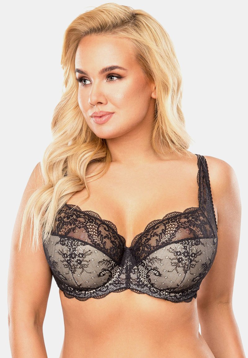 Reggiseno in pizzo nero caratterizzato da un design semi-trasparente con motivi floreali, bordi scallop, coppe lisce e spalline regolabili.