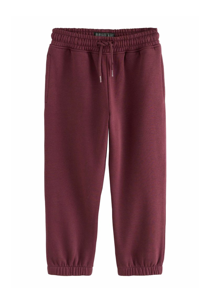 Bordeaux joggerbukser med elastisk talje og snøre, sidelommer og elastiske cuffs, lagt fladt ud på hvid baggrund.