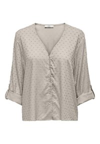 Blusa beige chiaro con scollatura a V, maniche a tre quarti, dettagli con bottoni e tessuto testurizzato caratterizzato da piccoli punti in rilievo.