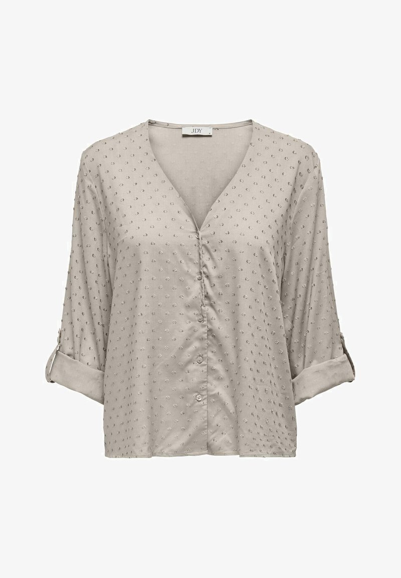 Světle béžová blůza s výstřihem do V, tříčtvrtečními rukávy, knoflíkovými detaily a texturovanou tkaninou s malými, vyvýšenými tečkami po celé ploše.
