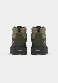 Green and gray high-top hiking boots feature a padded collar, suede and mesh materials, textured rubber sole, and logo detail on the heel.