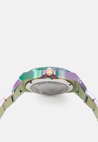 Montre en métal multicolore avec un boîtier circulaire, un cristal plat et une couronne rose. Le bracelet présente un design de maillons et une finition irisée brillante.