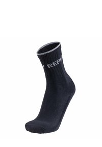 Chaussette noire à la cheville en tissu côtelé, avec un revers argenté contrastant et du texte imprimé sur le c�ôté. Texture lisse, design ajusté.