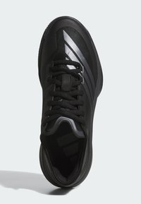 Chaussure de sport noire avec une tige en maille texturée, design à lacets et accents noirs brillants. Comprend un talon courbé et une silhouette épurée.
