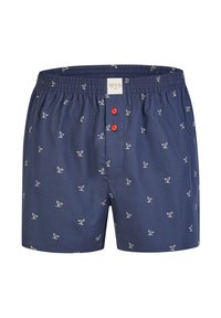 Boxer in cotone blu scuro con motivo di uccelli bianchi, dotati di chiusura a bottone rosso sul davanti e di una fascia elastica in vita per garantire comfort.