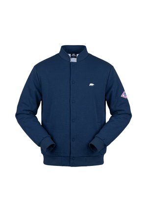 Marineblaue Bomberjacke mit Druckknöpfen, kleinem weißem Bärenlogo auf der Brust, gerippten Bündchen und Saum sowie einem diamantförmigen Aufnäher am linken Ärmel.