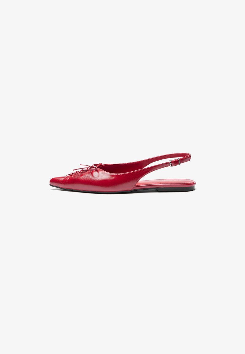 Red leather slingback flat shoe with a pointed toe and a decorative lace-up detail on the front, featuring a slim ankle strap and flat sole.