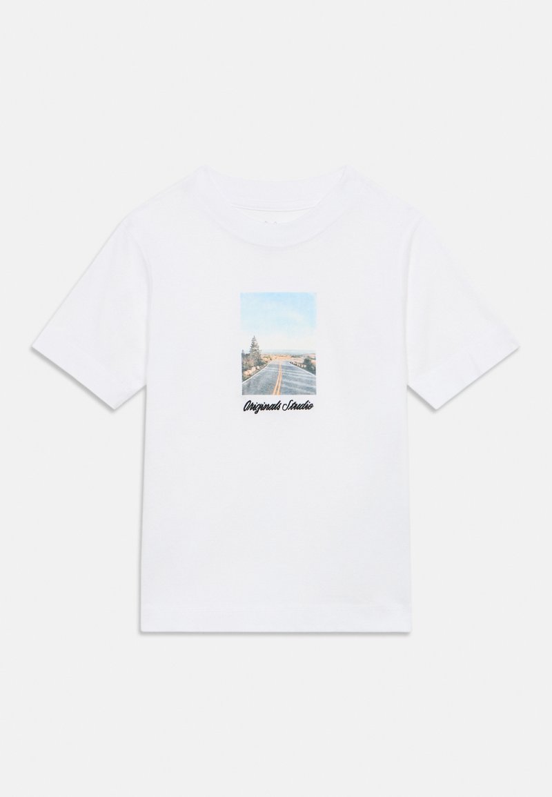 Λευκό βαμβακερό T-shirt με ορθογώνιο σχέδιο που απεικονίζει μια σκηνή δρόμου με γαλάζιο ουρανό και δέντρα, με την επιγραφή «Originals Studio» σε μαύρο κείμενο.