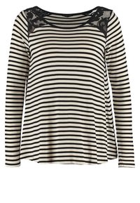 Långärmad topp i krämfärgat och svart randigt mönster, med en spetsdetalj vid halslinjen. Mjuk tyg med avslappnad passform och rundad nederkant.