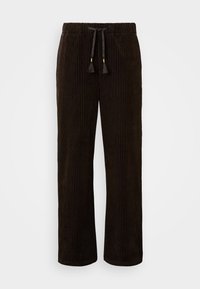 Tumši brūnas kordurojas bikses ar mīkstu tekstūru, kurām ir aukliņu jostasvieta ar bārkstīm un taisna kāju konstrukcija. Vertikāls rilētu raksts.