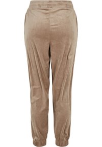 Velvet joggerbyxor i ljusbrun färg med en mjuk textur, elastisk midja och åtsittande muddar vid anklarna, med sidfickor.