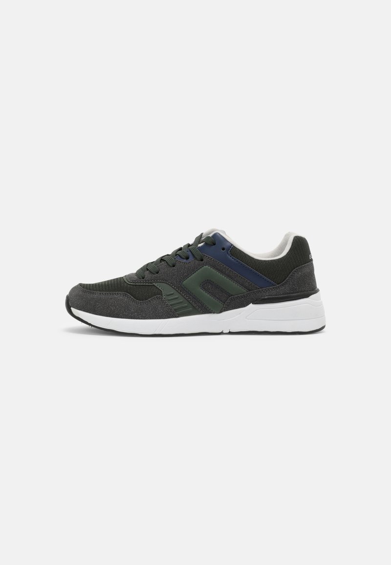 Running shoes with a dark grey upper, green and navy accents, a textured fabric finish, and a white rubber sole.