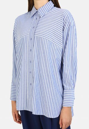 Button-up shirt in light blue with white vertical stripes, featuring a collar, long sleeves, and a straight hem, made of a soft fabric.