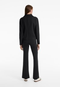 OYSHO NEOPRENE-EFFECT RISE FLARE  - Hlače - black