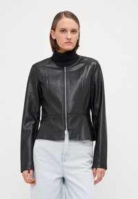 Black leather jacket with a fitted design, round neckline, and front zipper. Features long sleeves and a smooth, glossy texture.