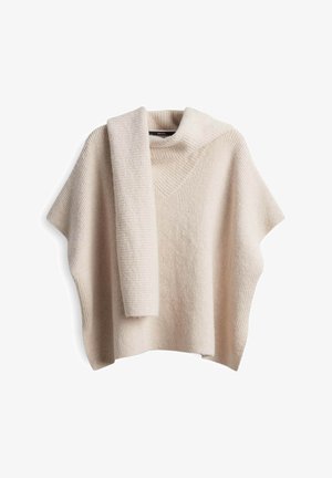 Cream-colored knitted poncho with a matching scarf draped over the shoulder, featuring a high neckline and ribbed texture.