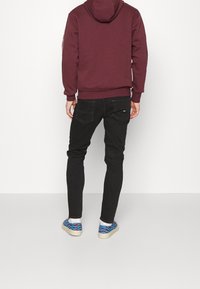 Tommy Jeans Jeans Tapered Fit - black denim