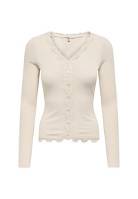 Pitkähiha, ribattu vaalea paita, jossa on V-pääntie, keskellä pitsipaneeli, jossa on napit ja sahalaitapitsireuna pääntiellä ja helmassa.