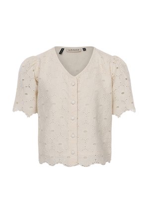 Blouse crème à manches courtes avec broderie œillets florale, boutons ronds recouverts de tissu sur le devant et encolure en V.