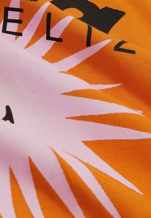 Orange fabric featuring a large pink sunburst graphic with black lettering. Texture is smooth with a slightly stretchy appearance.