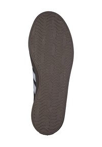 Black sole with textured wavy pattern; three white stripes on side; rubber material; designed for traction and stability.