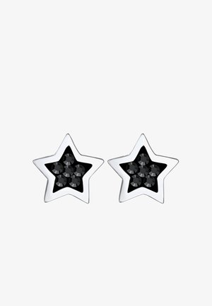 Orecchini a forma di stella in argento con un centro in smalto nero e cinque gemme nere disposte a grappolo. Finitura in metallo lucido.