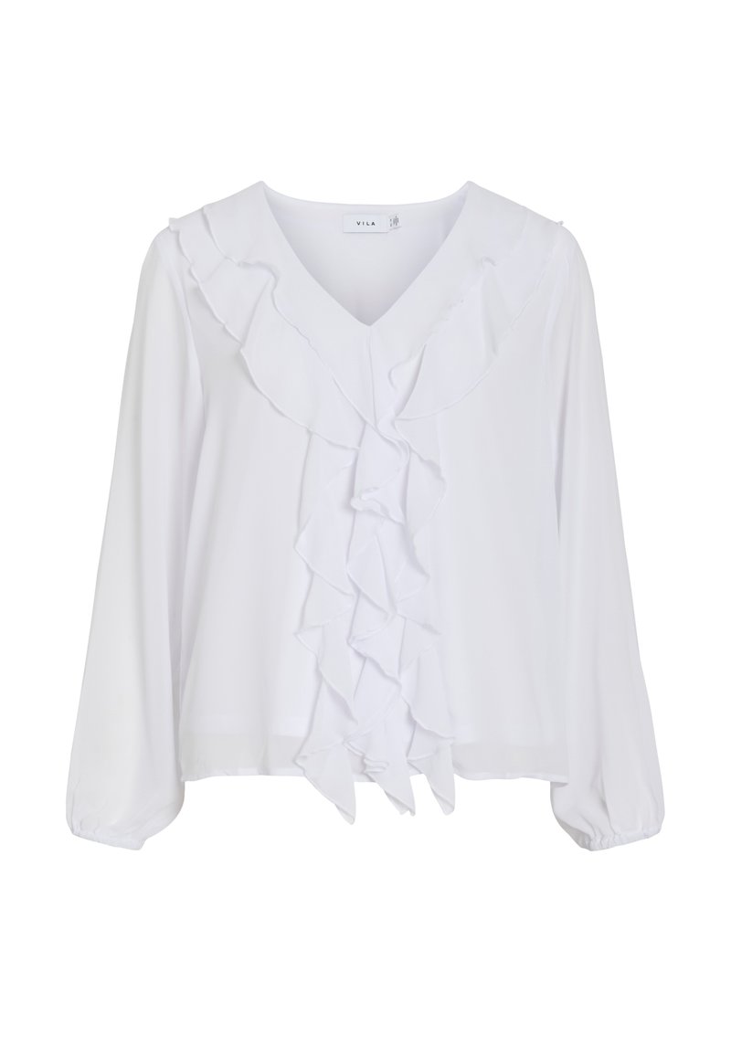 Blouse blanche à manches longues avec col en V et détails de volants superposés sur le devant et autour de l'encolure.