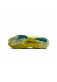 Suela de zapatilla Nike en amarillo y teal con un patrón de espiga. Presenta un logo marrón y surcos distintivos para mejorar la tracción.